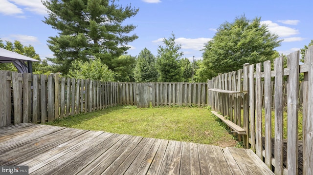 wooden terrace with a lawn