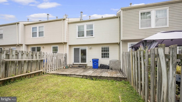 back of property with a gazebo, a yard, and a deck