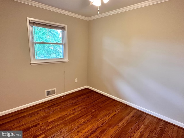 spare room featuring ornamental molding and hardwood / wood-style floors