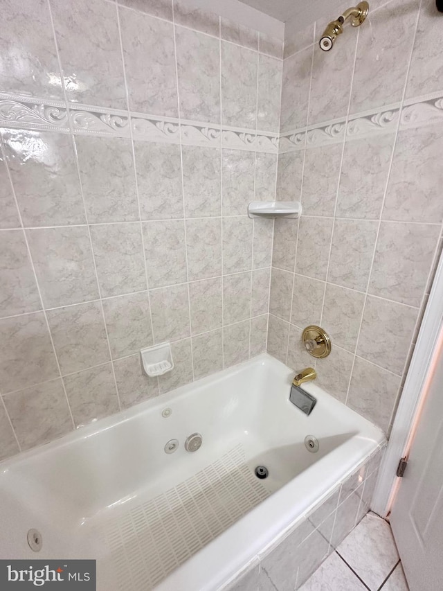 bathroom with tile patterned flooring and tiled shower / bath