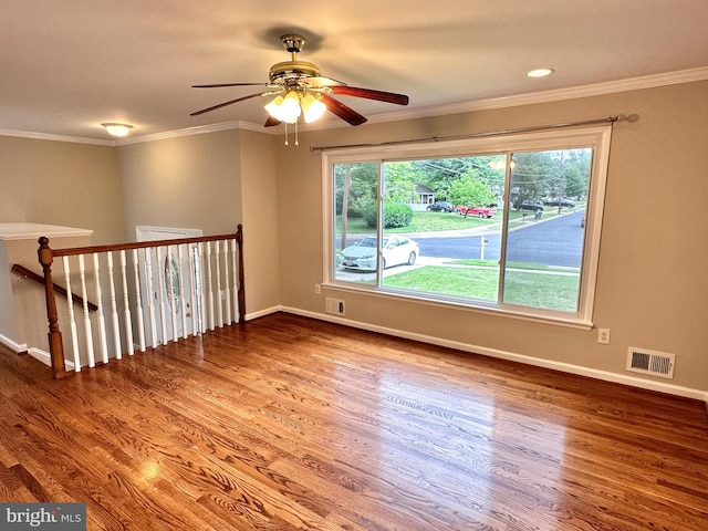 unfurnished room with ornamental molding, hardwood / wood-style floors, and ceiling fan