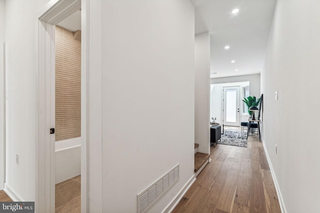 hallway with hardwood / wood-style flooring