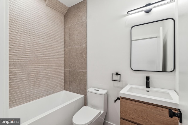 full bathroom with vanity, tiled shower / bath combo, and toilet