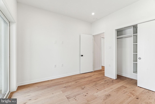 unfurnished bedroom featuring a closet and light hardwood / wood-style flooring