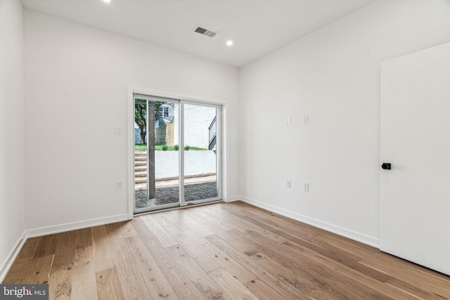 spare room with light hardwood / wood-style flooring