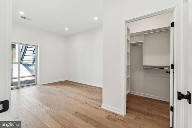 interior space featuring access to outside, a closet, and light hardwood / wood-style floors