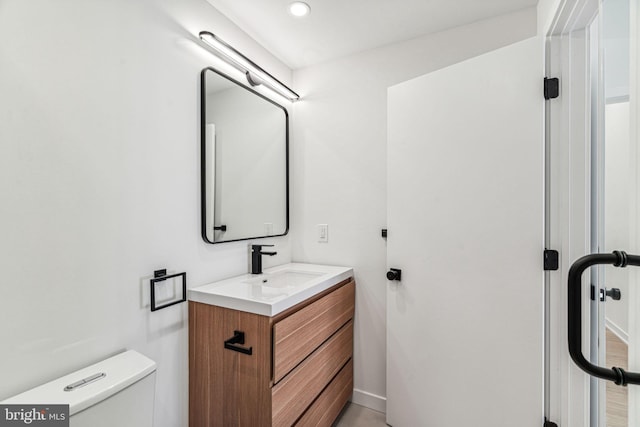 bathroom featuring vanity and toilet