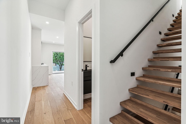 stairs with hardwood / wood-style floors