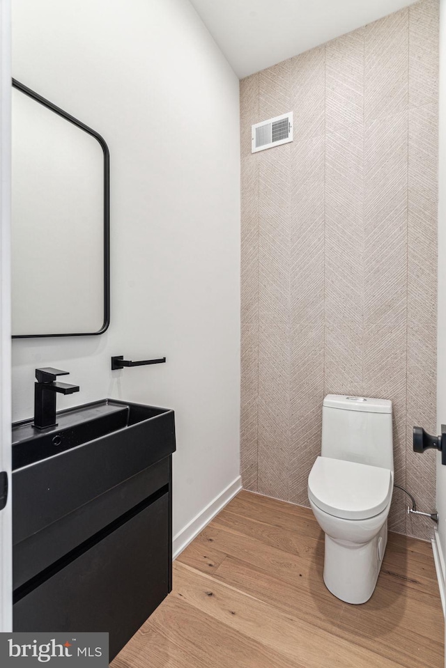 bathroom featuring hardwood / wood-style floors, vanity, and toilet