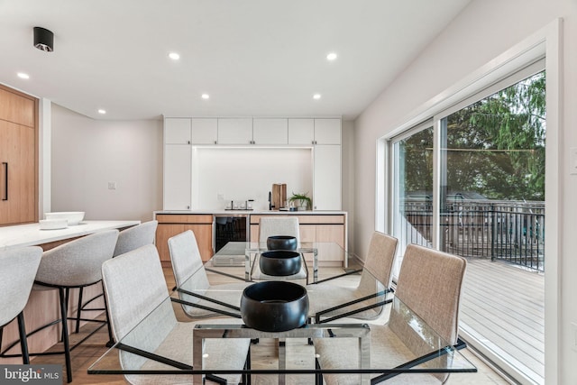 dining room with light hardwood / wood-style flooring and wine cooler