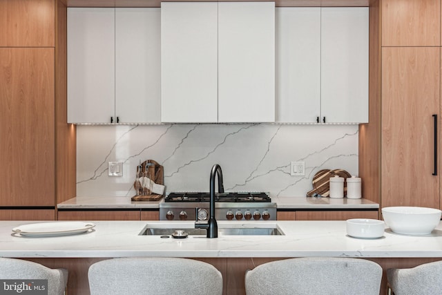 kitchen with white cabinets and a kitchen bar