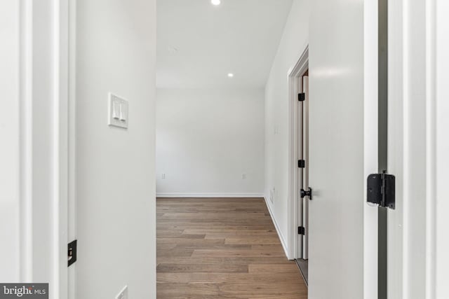 hallway with light hardwood / wood-style floors