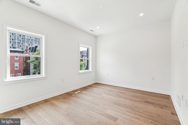 unfurnished room featuring light wood-type flooring