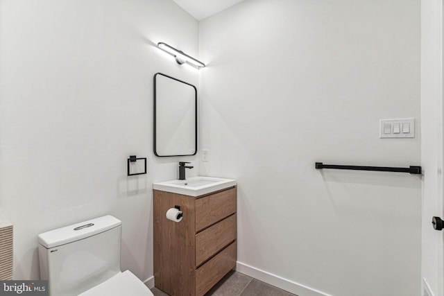 bathroom featuring tile patterned flooring, vanity, and toilet