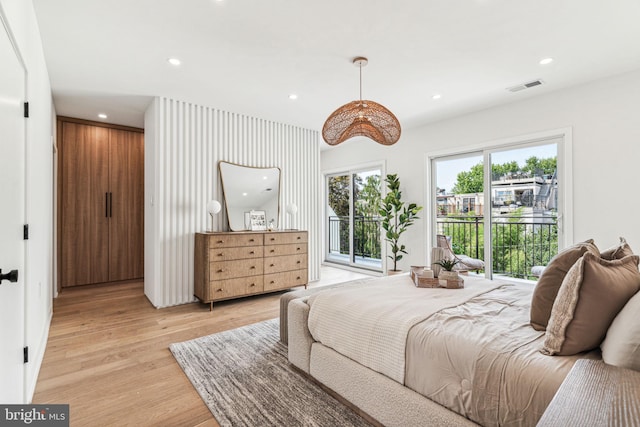 bedroom featuring access to exterior and light hardwood / wood-style floors