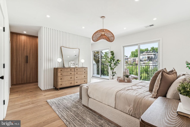 bedroom with access to exterior and light wood-type flooring