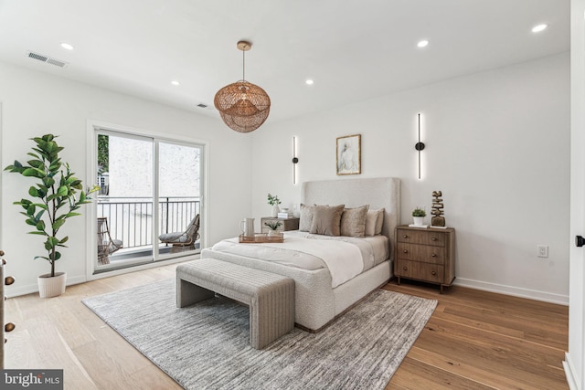 bedroom with access to exterior and light hardwood / wood-style floors