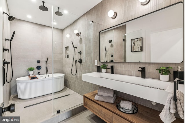 bathroom with tile patterned flooring, tile walls, and plus walk in shower