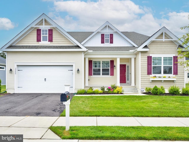 craftsman inspired home featuring a garage and a front yard