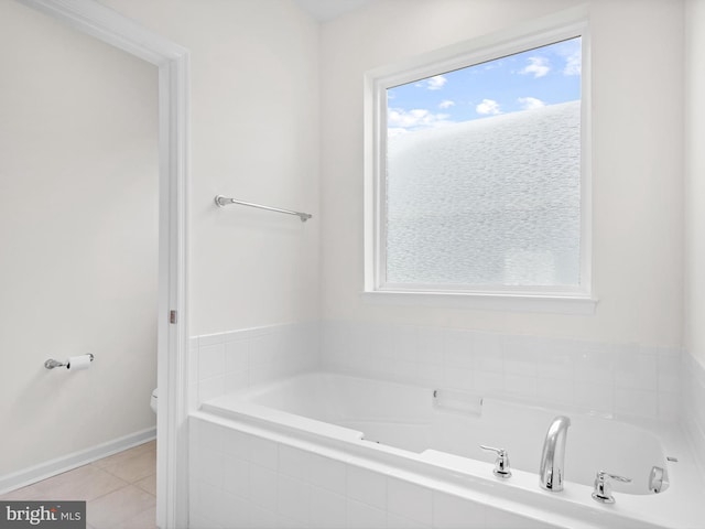 bathroom with tile flooring and a relaxing tiled bath