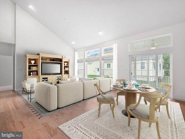 living room featuring high vaulted ceiling and hardwood / wood-style floors