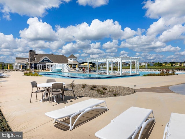 view of swimming pool with a patio area and a pergola