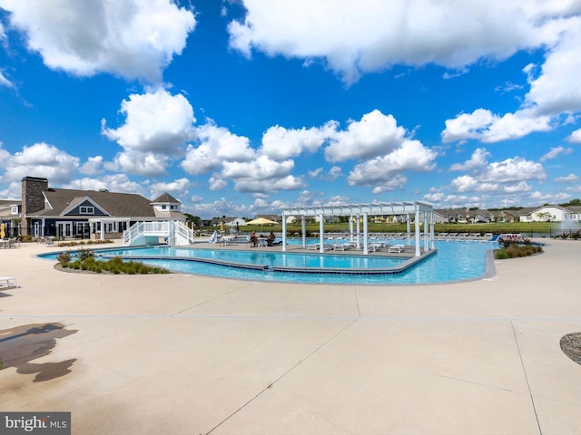 view of pool with a pergola and a patio area