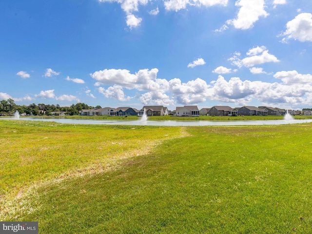 view of nearby features featuring a lawn and a water view