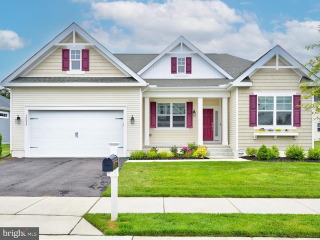 craftsman inspired home with a garage and a front yard