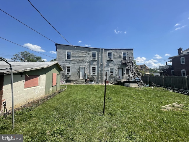 rear view of house with a yard