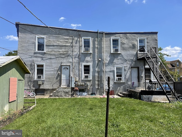 back of property featuring a lawn