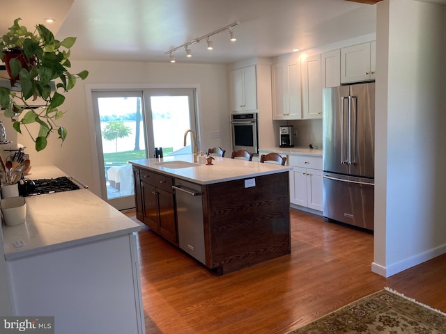 kitchen featuring white cabinets, stainless steel appliances, dark hardwood / wood-style floors, and sink