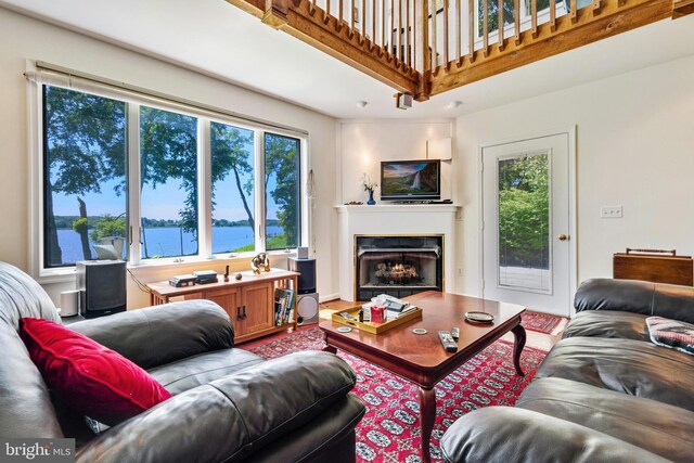 bedroom featuring a water view and wood finished floors