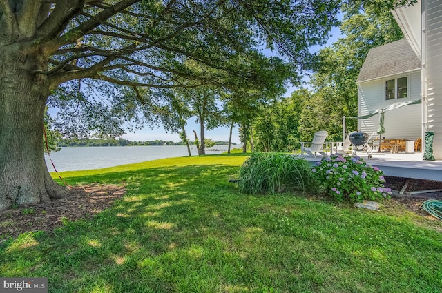 view of yard with a water view and a patio area