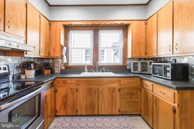 kitchen featuring sink, tasteful backsplash, light tile floors, and stainless steel appliances