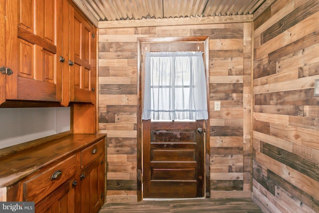 interior space with wooden walls, hardwood / wood-style flooring, and wooden ceiling