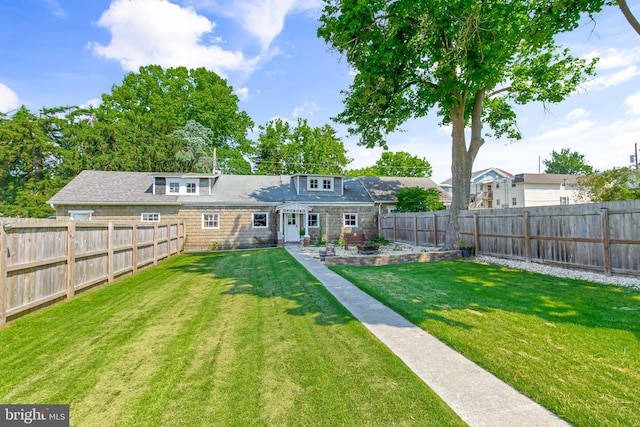 back of property with a lawn and a patio area