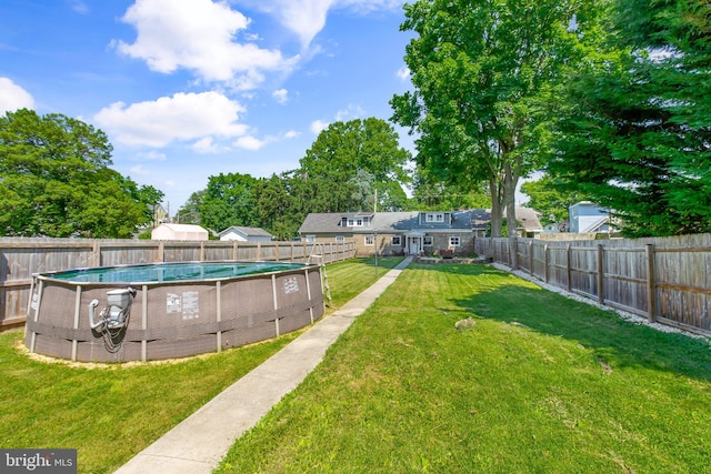 view of swimming pool with a yard