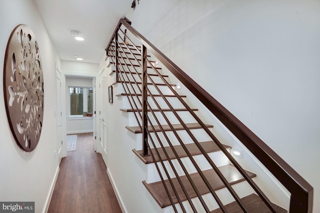 stairs with dark wood-type flooring