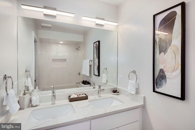 bathroom featuring tiled shower / bath combo and double sink vanity