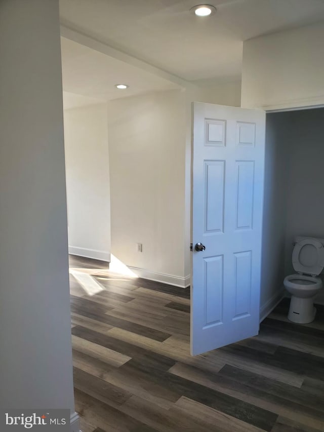 corridor featuring dark hardwood / wood-style floors