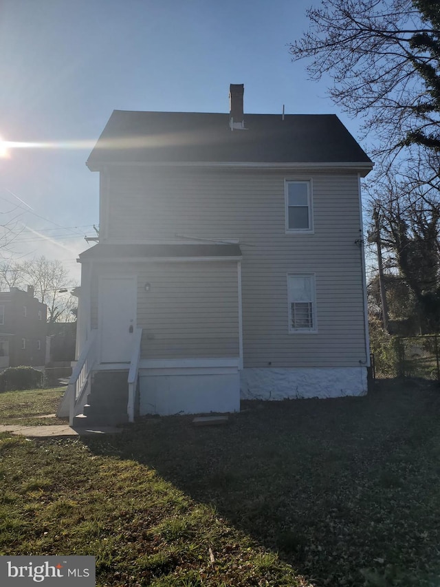 rear view of house with a yard