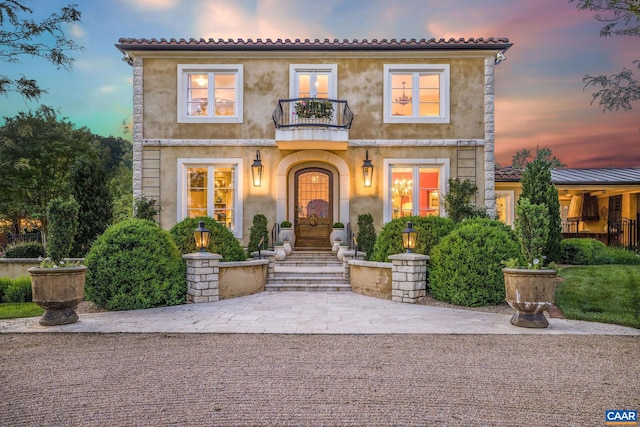 mediterranean / spanish-style home featuring a balcony