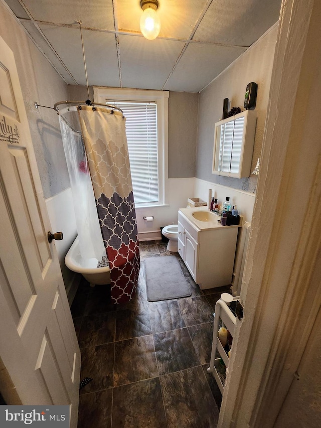 bathroom featuring vanity and toilet