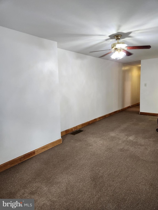 spare room featuring carpet and ceiling fan