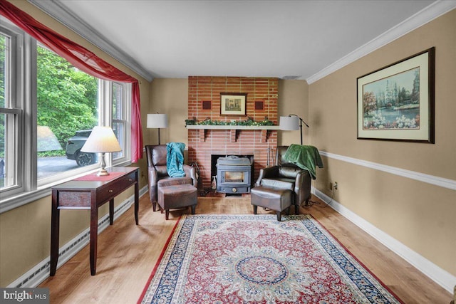 living area featuring hardwood / wood-style floors, a brick fireplace, a wood stove, brick wall, and ornamental molding