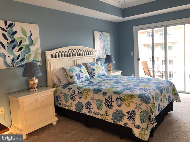 carpeted bedroom featuring multiple windows, crown molding, and access to outside