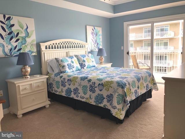 bedroom featuring access to exterior and carpet floors