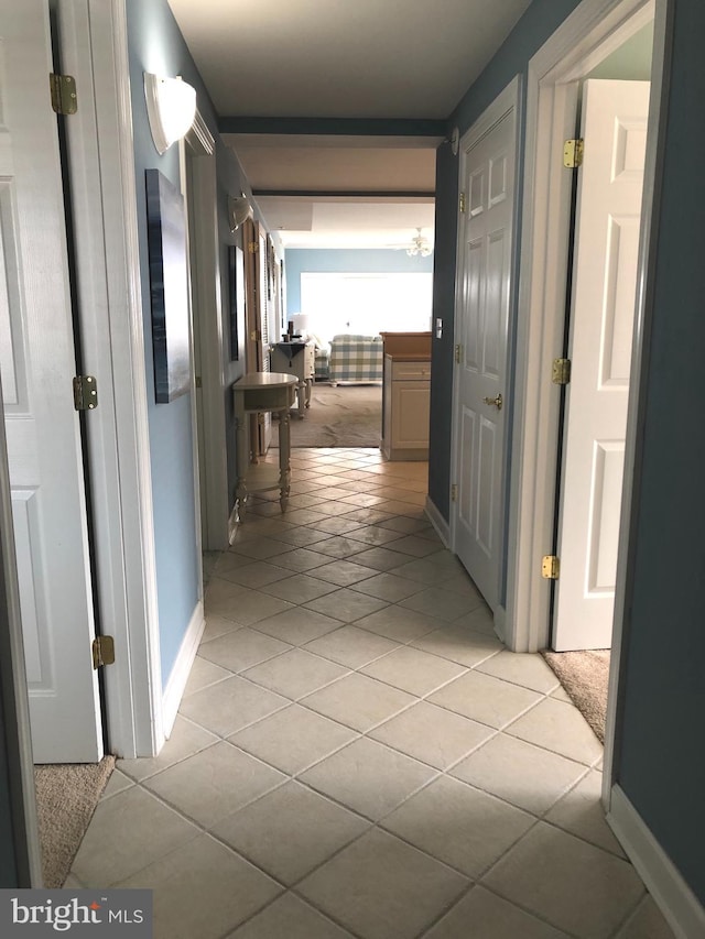 hallway featuring light tile floors