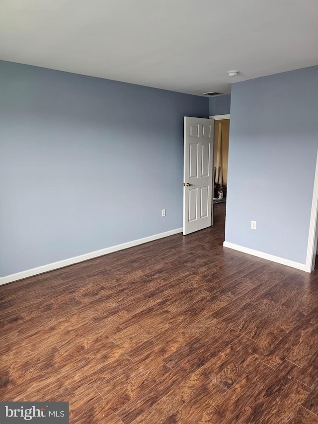 empty room featuring dark wood-type flooring